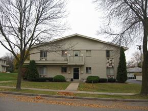 Waukesha apartment for rent - A two-story house with a garage on the ground floor.