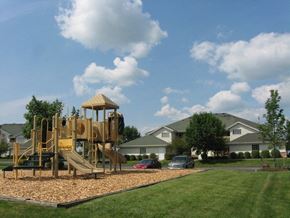 Watertown apartment for rent - a playground in a yard in front of some houses