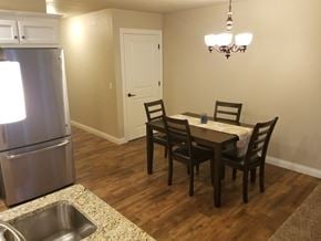 Sheboygan apartment for rent - a kitchen and dining room with a table and chairs and a refrigerator