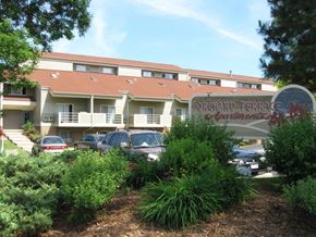 Milwaukee apartment for rent - a building with a sign and cars parked in front of it