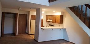 Milwaukee apartment for rent - an empty kitchen with a refrigerator and a staircase