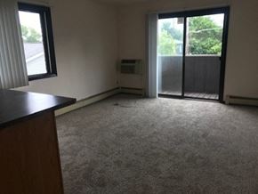 St Francis apartment for rent - an empty living room with a door to a balcony