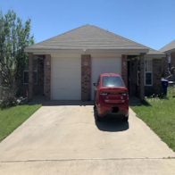 Copperas Cove apartment for rent - A red car is parked in front of a house.