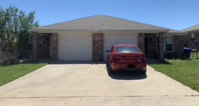 Copperas Cove apartment for rent - A red car is parked in front of a house.