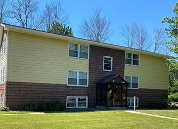 Hamburg apartment for rent - A two-story house with a yellow siding and a brown trim.