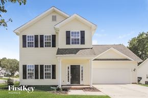 Charlotte house for rent - A two-story house with a white exterior and a black door.