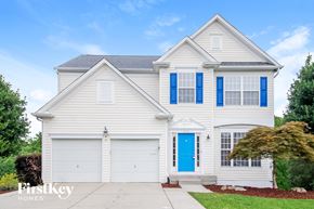 Jamestown house for rent - A two-story house with a blue front door and windows.