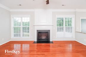 Jamestown house for rent - A living room with a fireplace and wood floors.
