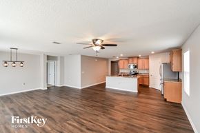 Jacksonville house for rent - A spacious kitchen with wooden floors and a ceiling fan.