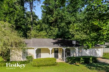 Marietta house for rent - a white house with a yard and trees