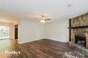 Marietta house for rent - a living room with a fireplace and a ceiling fan
