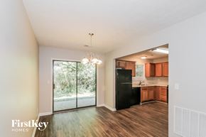 Marietta house for rent - an empty living room with a kitchen and a sliding glass door