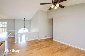 Flowery Branch house for rent - a living room with a ceiling fan and a wooden floor