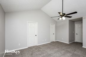 Flowery Branch house for rent - a bedroom with two doors and a ceiling fan