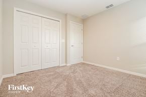 Zephyrhills house for rent - a bedroom with two closets and a carpeted floor