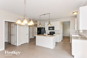 St Peters house for rent - a large kitchen with white cabinets and a white counter top