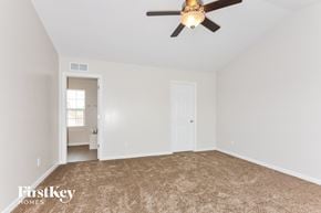 St Peters house for rent - a bedroom with a ceiling fan and a carpeted floor