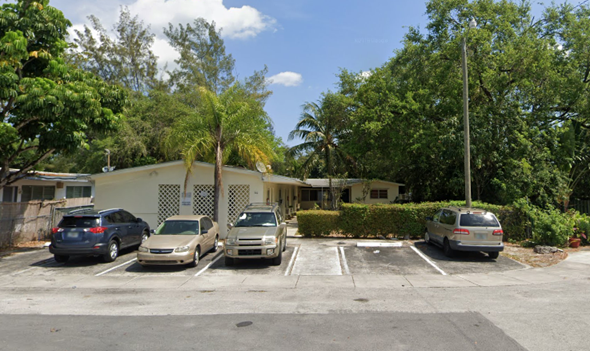 North Miami apartment for rent - a parking lot with cars in front of a house