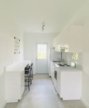 North Miami Beach apartment for rent - an empty kitchen with white cabinets and a counter top