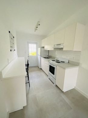 North Miami Beach apartment for rent - an empty kitchen with white cabinets and a stove