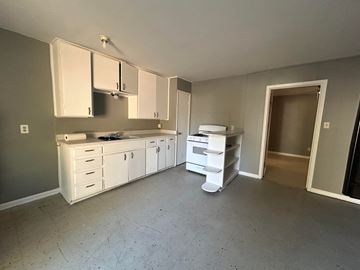 Killeen apartment for rent - A kitchen with white cabinets and a countertop is shown.