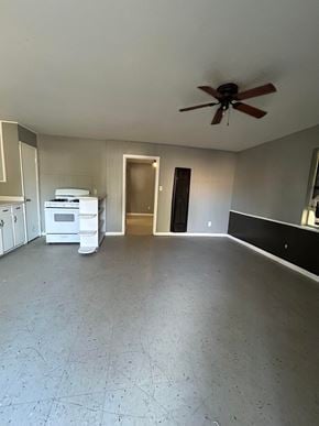 Killeen apartment for rent - A room with a ceiling fan and a white appliance.