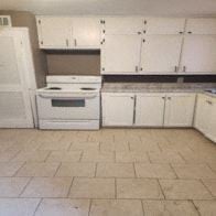 Temple apartment for rent - an empty kitchen with white cabinets and a stove