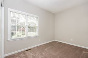 Concord house for rent - an empty bedroom with a large window and carpeting