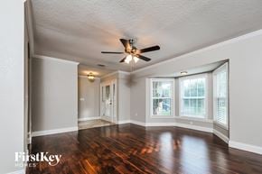 Lakeland house for rent - A room with a ceiling fan and wooden floors.