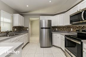 Davenport house for rent - a kitchen with white cabinets and a stainless steel refrigerator