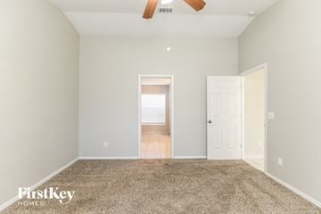 Davenport house for rent - a spacious living room with carpet and a ceiling fan