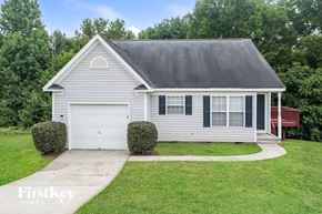 Monroe house for rent - A house with a grey roof and a white garage door.