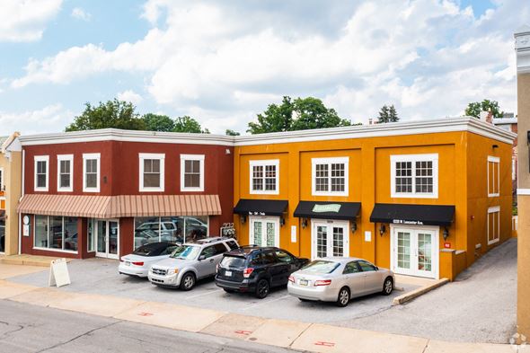 Bryn Mawr apartment for rent - A row of stores with cars parked in front.