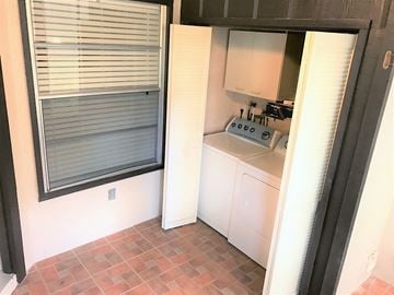 Bradenton house for rent - a small kitchen with a window and a white dishwasher