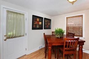 Albany townhouse for rent - a dining room with a wooden table and chairs