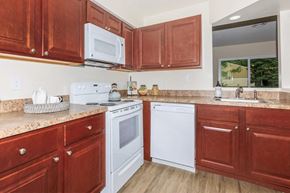 Clifton Park apartment for rent - a kitchen with white appliances and wooden cabinets