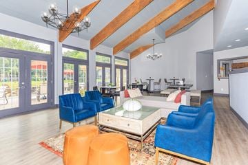 Clifton Park apartment for rent - a living room with blue chairs and a table     and a large
