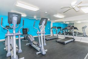 Clifton Park apartment for rent - a gym with weights and cardio equipment and a ceiling fan