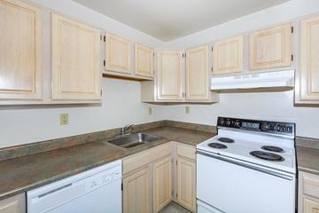 Clifton Park apartment for rent - a kitchen with white appliances and wooden cabinets