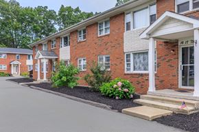 Clifton Park apartment for rent - the front of a brick apartment building with steps and landscaping