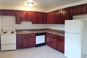 Clifton Park apartment for rent - a kitchen with wooden cabinets and a white refrigerator