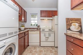 Ithaca apartment for rent - a kitchen with white appliances and wooden cabinets