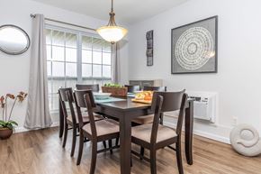 Ithaca apartment for rent - a dining room with a table and chairs and a window