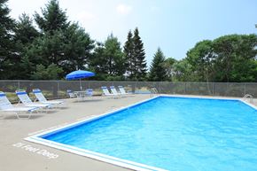 Ithaca apartment for rent - a resort style pool with chairs and an umbrella