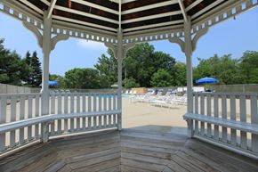 Ithaca apartment for rent - a covered porch with a view of the beach and chairs