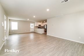 Converse house for rent - A spacious empty room with wooden flooring and white walls.