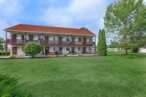 Mechanicville apartment for rent - a large lawn in front of a building with a red roof