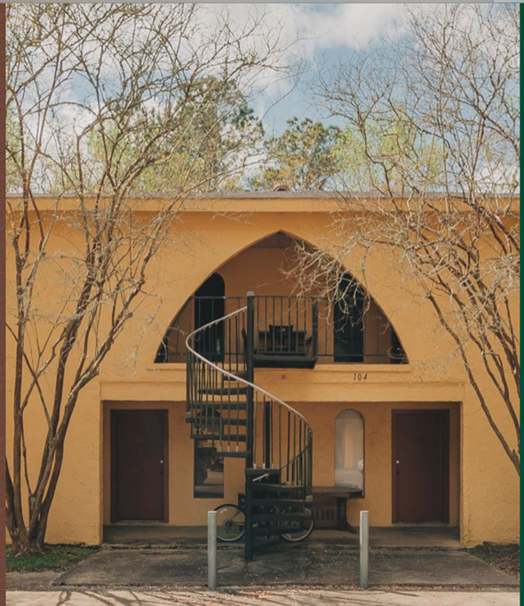 Hammond apartment for rent - a building with a spiral staircase  and a tree