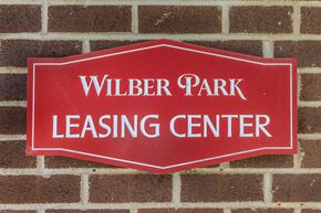 Oneonta apartment for rent - a red sign on a brick wall saying wildlife park leasing center