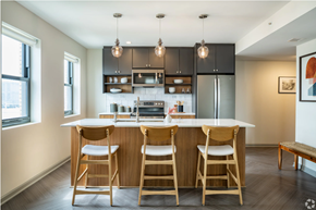 Detroit apartment for rent - a kitchen with a bar and stools in a house